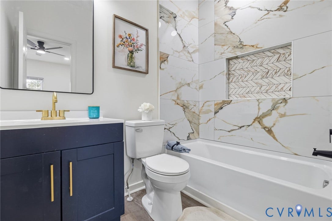409 S Jefferson Street, Bolling, Petersburg, VA 23803 Blue vanity with gold-finish hardware, gold-finish faucet, and a rectangular mirror