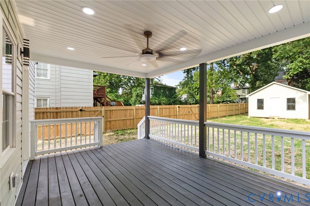409 S Jefferson Street, Bolling, Petersburg, VA 23803 Expansive covered deck featuring composite decking, white aluminum railings, and ceiling-mounted fan