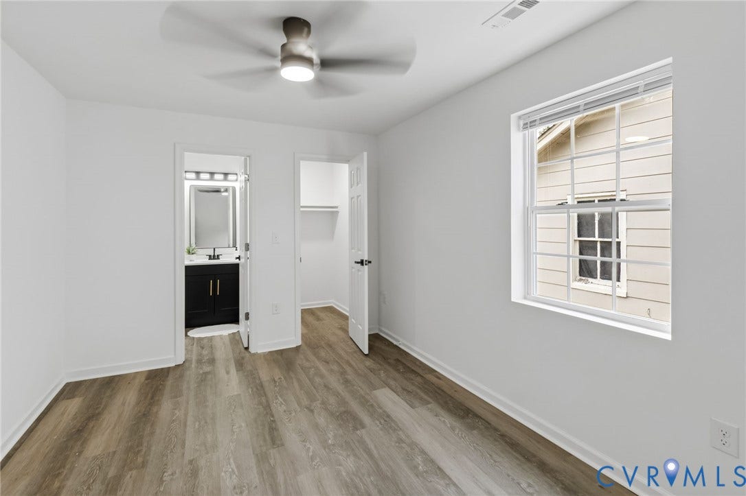 409 S Jefferson Street, Bolling, Petersburg, VA 23803 Room featuring wood-finish flooring, a ceiling fan, and a window with blinds