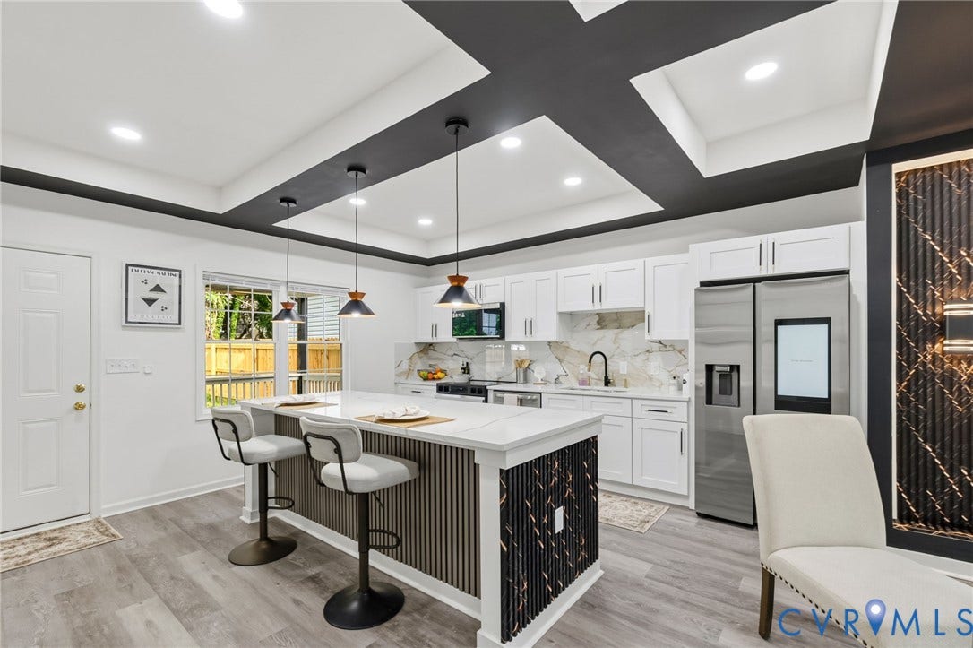 409 S Jefferson Street, Bolling, Petersburg, VA 23803 Kitchen featuring a tray ceiling, recessed lighting, central island with seating, white cabinetry, and stainless steel appliances