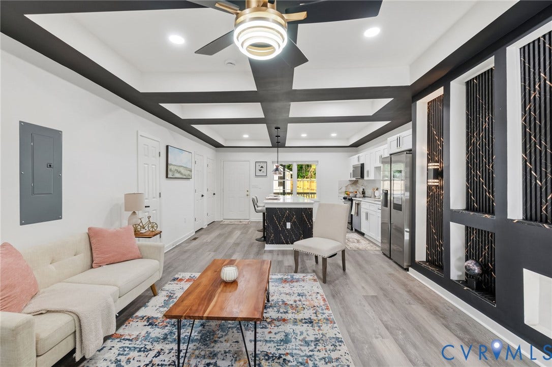 409 S Jefferson Street, Bolling, Petersburg, VA 23803 Modern living space showcasing a coffered ceiling with recessed lighting and ceiling fan, wide-plank wood-finish flooring throughout, and a curved cream-colored sectional