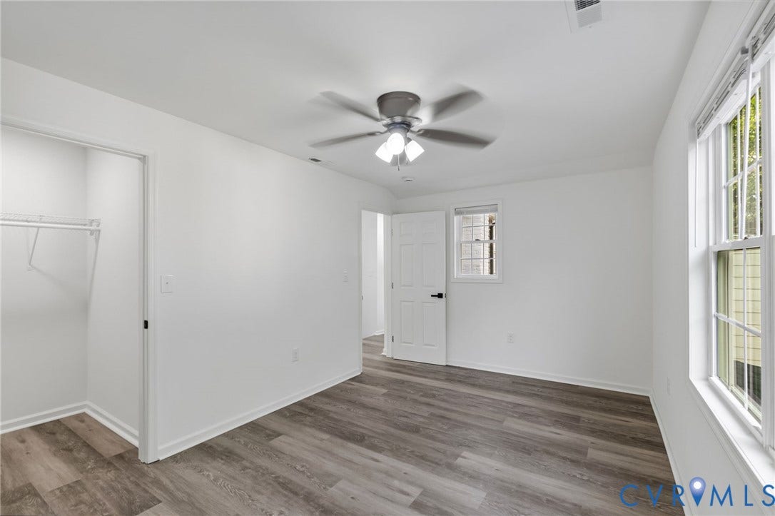 409 S Jefferson Street, Bolling, Petersburg, VA 23803 Wood-finish flooring, white walls, ceiling fan with integrated lighting, and multiple windows