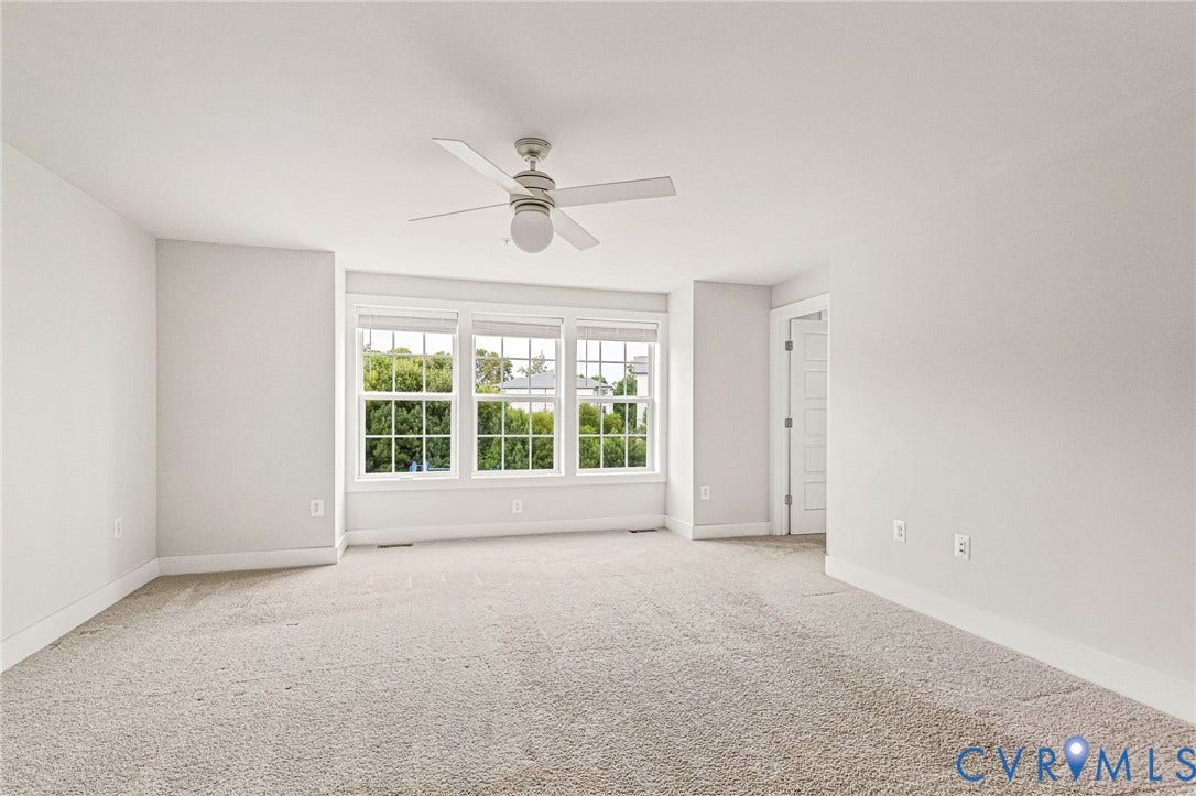 4347 Saunders Station Loop, #A, Glen Allen, VA 23233 Neutral wall color, carpeted flooring, multi-pane windows, and a ceiling fan with integrated lighting
