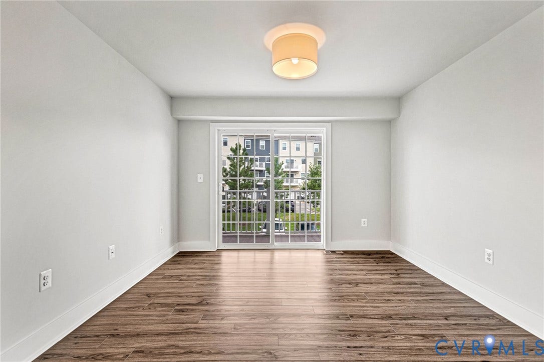 4347 Saunders Station Loop, #A, Glen Allen, VA 23233 Bright and spacious room flooded with natural light through French doors, featuring warm wood-finish flooring, clean white walls, and recessed ceiling lighting