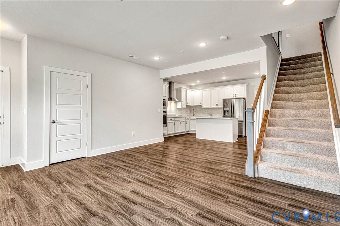 4347 Saunders Station Loop, #A, Glen Allen, VA 23233 Open concept living area with wood-finish flooring, recessed lighting, and a modern kitchen featuring white cabinetry and stainless steel appliances