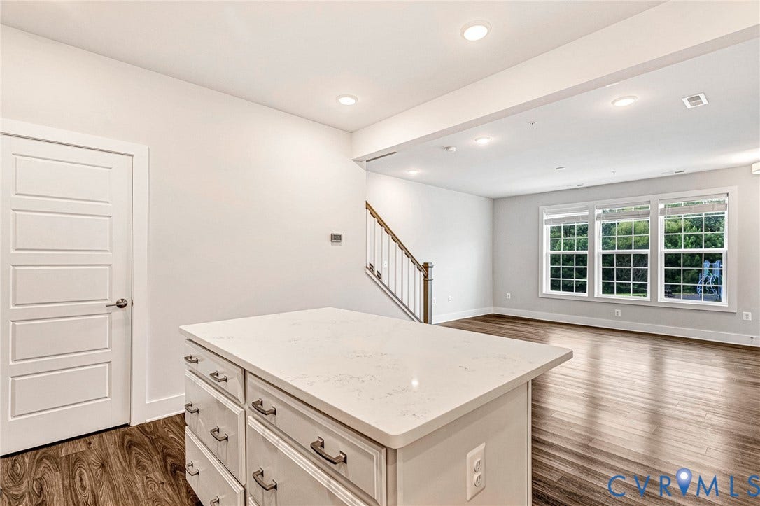 4347 Saunders Station Loop, #A, Glen Allen, VA 23233 Bright, open loft space featuring recessed ceiling lighting, hardwood flooring, and an oversized kitchen island with white cabinetry and white quartz countertop