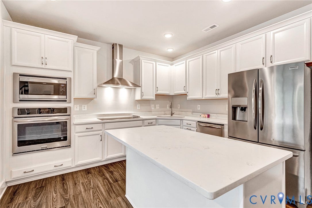 4347 Saunders Station Loop, #A, Glen Allen, VA 23233 Kitchen featuring an island, white cabinetry, stainless steel appliances, a range hood, and wood-finish flooring