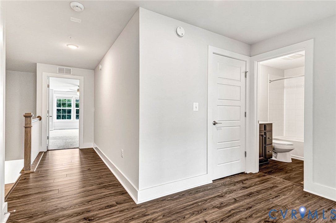 4347 Saunders Station Loop, #A, Glen Allen, VA 23233 Wood-finish flooring throughout, bright white walls, contemporary five-panel interior doors, modern recessed lighting, and a bathroom featuring a white bathtub with tile surround