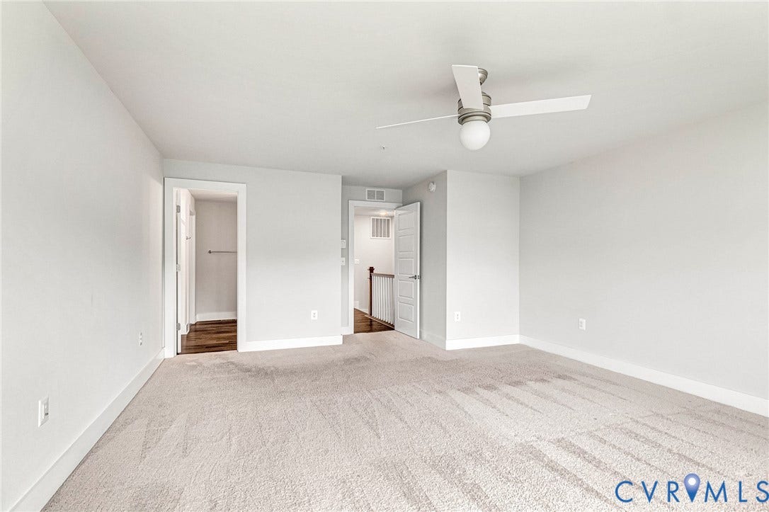 4347 Saunders Station Loop, #A, Glen Allen, VA 23233 Spacious bedroom with neutral wall finishes, ceiling fan with integrated lighting, and neutral-toned carpet flooring