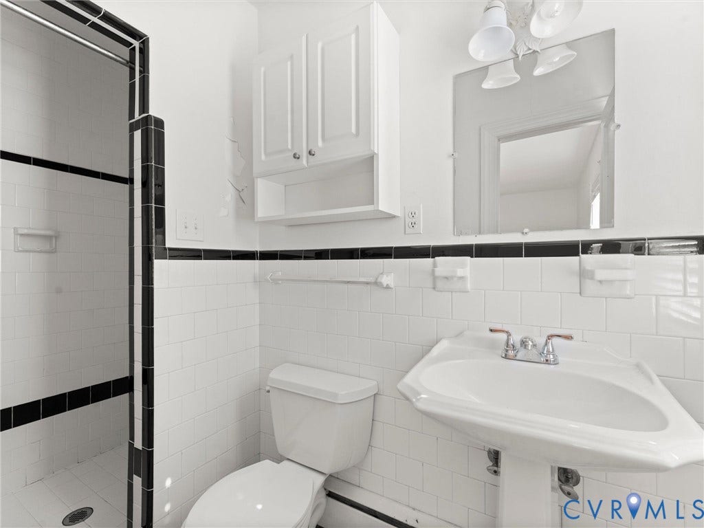 4608 Grove Avenue, Mary Munford, Richmond, VA 23226 Ensuite bath with black and white tiled shower, pedestal sink and tile floors.