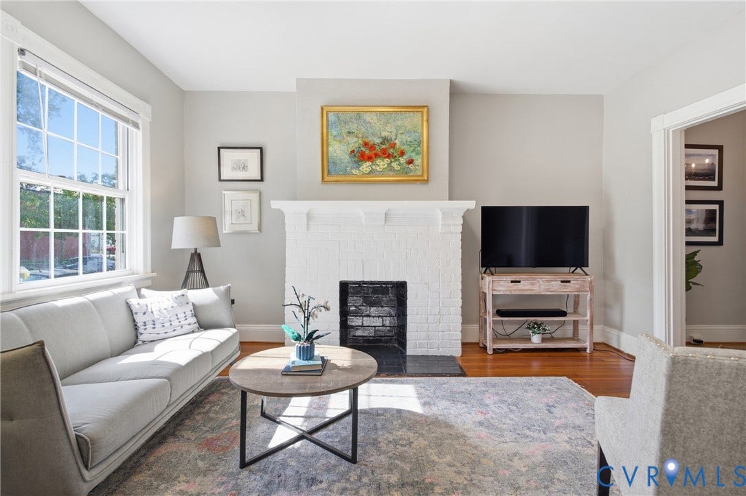 212 S Belmont Avenue, Carytown, Richmond, VA 23221 Hardwood flooring, painted brick fireplace, white mantle, white trim, and a large window