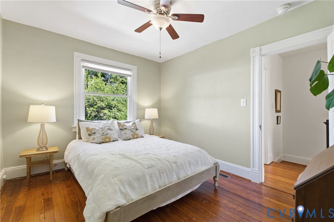 212 S Belmont Avenue, Carytown, Richmond, VA 23221 Hardwood flooring throughout, ceiling fan with integrated lighting, single window with white trim, and a doorway with detailed molding