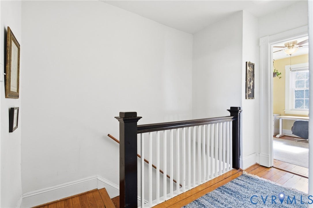 212 S Belmont Avenue, Carytown, Richmond, VA 23221 Hardwood flooring, painted white walls, and a wood banister with white spindles