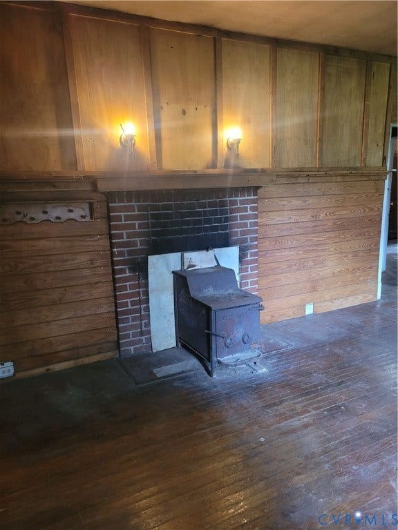 4617 Britannia Road, British Camp Farms, Richmond, VA 23234 Brick fireplace with a wood-burning stove, flanked by vertical wood paneling and horizontal wood wainscoting