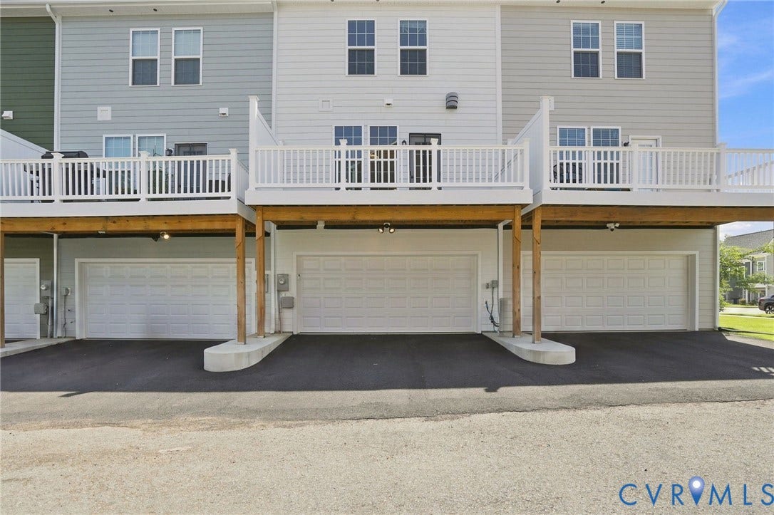 13820 Village View Drive, Midlothian, VA 23114 Rear exterior with multiple garages, upper-level decks with white railings, and light-toned siding