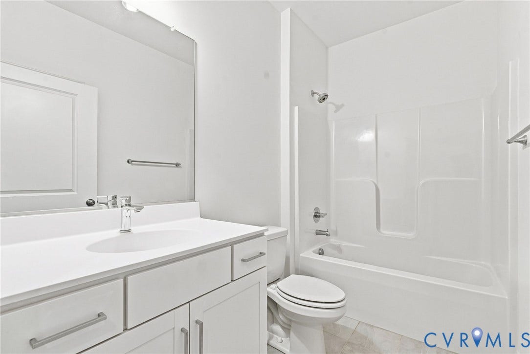 13820 Village View Drive, Midlothian, VA 23114 White vanity with integrated sink, chrome faucet, and rectangular mirror