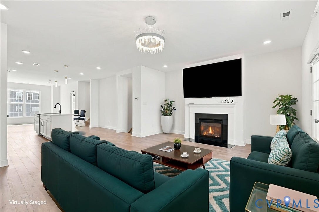 13820 Village View Drive, Midlothian, VA 23114 Open-concept living area with wood-finish flooring, recessed lighting, and a modern chandelier