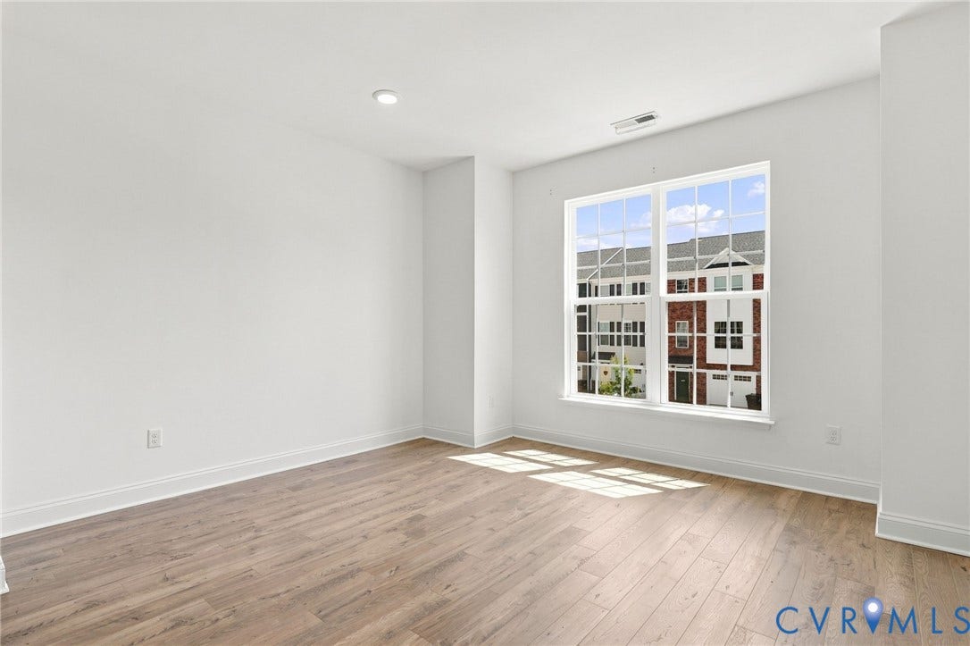 13820 Village View Drive, Midlothian, VA 23114 Wood-finish flooring, white walls, recessed ceiling lighting, and a large window with grid pattern