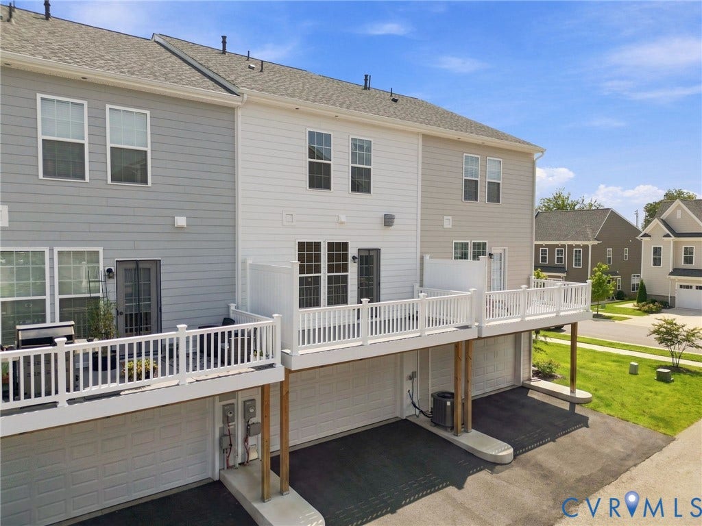 13820 Village View Drive, Midlothian, VA 23114 Multi-level property exterior featuring gray and white siding, dual-level decks with white railings, and integrated garage spaces