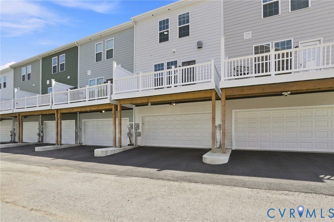 13820 Village View Drive, Midlothian, VA 23114 Townhome exterior with light gray siding, private balconies, individual garages, and paved driveways