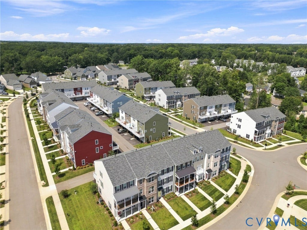 13820 Village View Drive, Midlothian, VA 23114 Community featuring townhome-style residences with covered balconies, individual parking spaces, and manicured landscaping