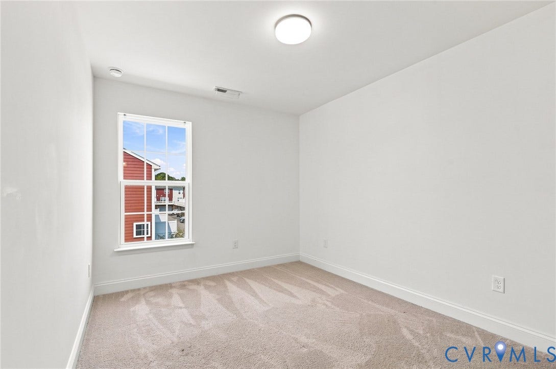 13820 Village View Drive, Midlothian, VA 23114 Neutral tone wall finishes, light-toned carpeting, and a double-hung window