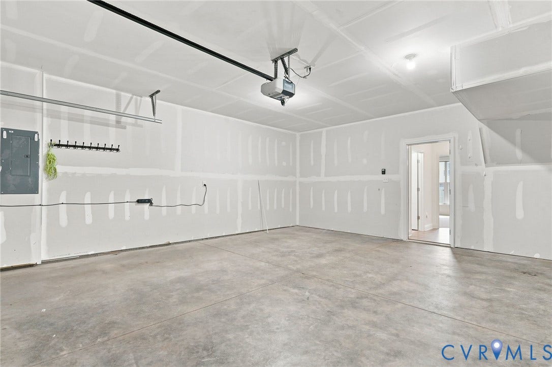 13820 Village View Drive, Midlothian, VA 23114 Spacious garage with unfinished walls, concrete flooring, and an overhead garage door opener