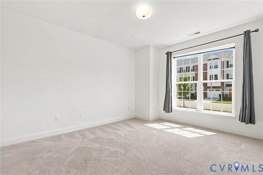 13820 Village View Drive, Midlothian, VA 23114 Wall-to-wall carpeting, white painted walls, and a multi-pane window with a light fixture