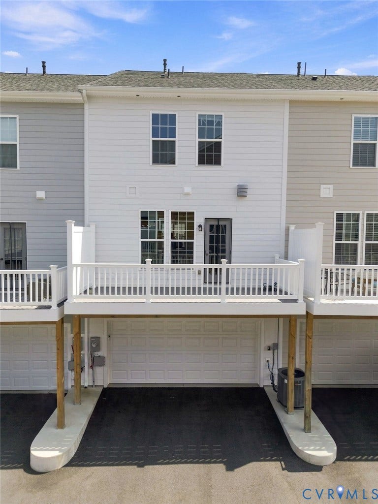 13820 Village View Drive, Midlothian, VA 23114 White vinyl siding exterior with an elevated deck featuring white railings