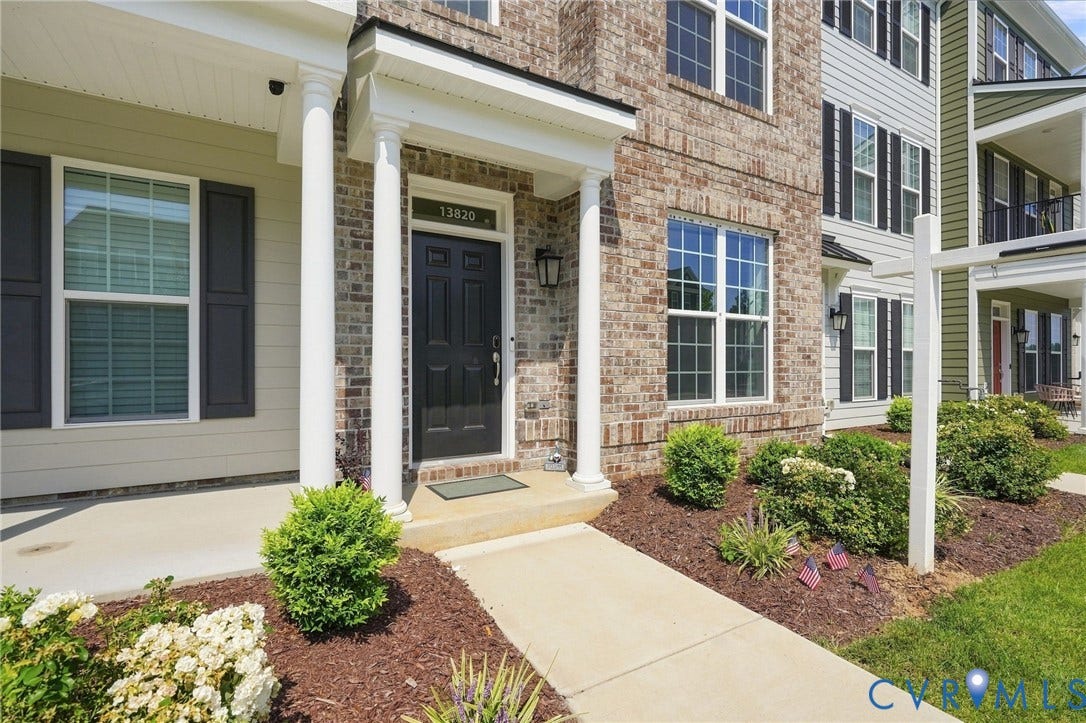 13820 Village View Drive, Midlothian, VA 23114 Brick and siding exterior with a paneled front door, white columns, and a concrete walkway