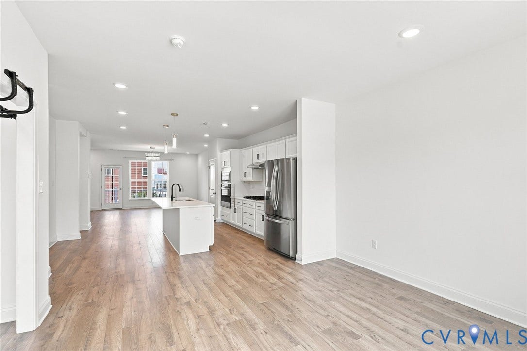 13820 Village View Drive, Midlothian, VA 23114 Bright open-concept interior featuring light wood-finish flooring, recessed lighting, and a kitchen island with pendant lighting