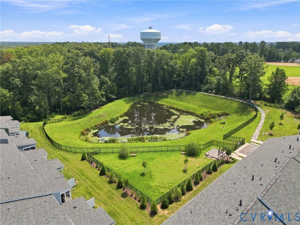 13820 Village View Drive, Midlothian, VA 23114 Landscaped grounds featuring a retention pond, surrounding green space, and a fenced pet amenity area