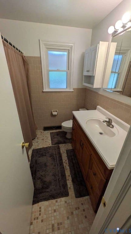 12853 Holly Lane, Manakin Sabot, VA 23103 Bathroom featuring a wood vanity with integrated sink, tiled walls, and mosaic tile flooring
