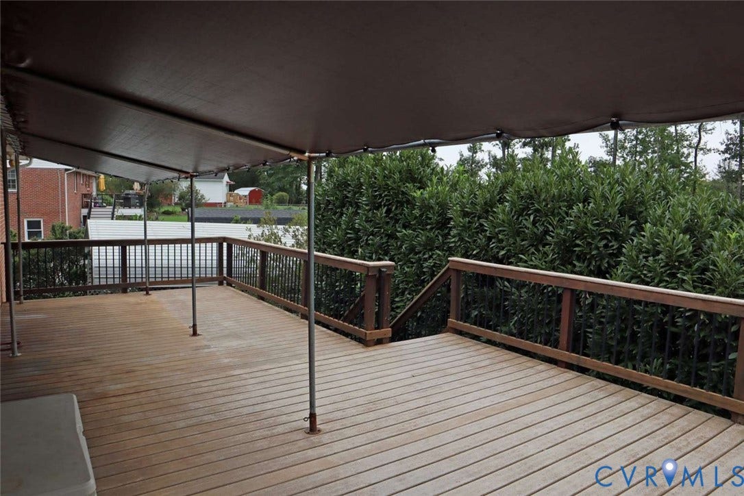 12853 Holly Lane, Manakin Sabot, VA 23103 Expansive wood deck with a dark brown overhead canopy, wood railings, and metal balusters