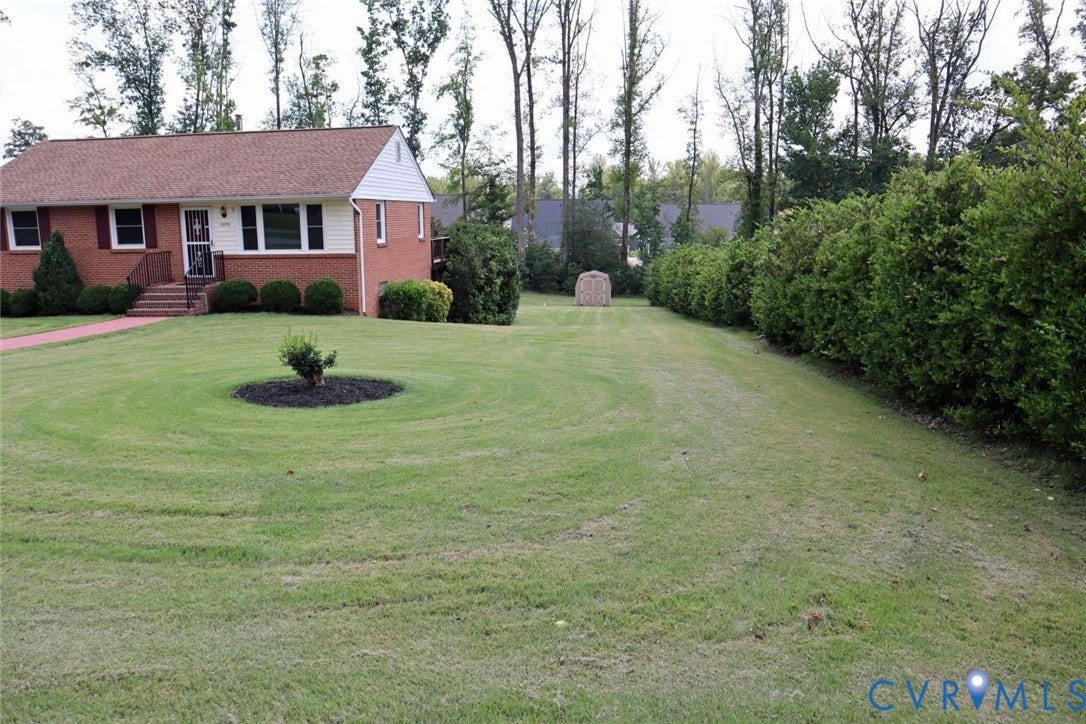 12853 Holly Lane, Manakin Sabot, VA 23103 Brick exterior, gabled roof, front porch with railings, established shrubbery, expansive lawn