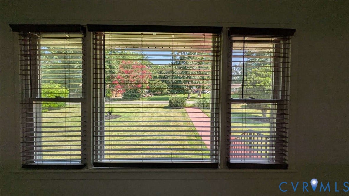 12853 Holly Lane, Manakin Sabot, VA 23103 Triple window unit with wood-finish blinds, framing a landscaped front yard with a brick pathway