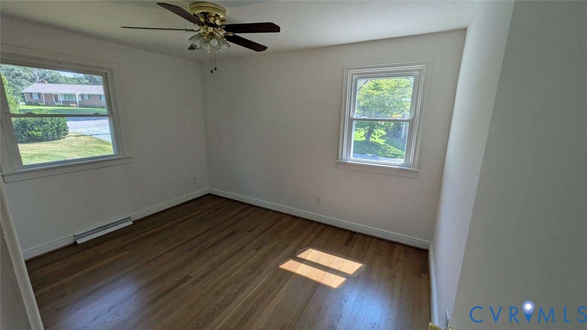 12853 Holly Lane, Manakin Sabot, VA 23103 Hardwood flooring, two windows, ceiling fan with light fixture, and white painted walls