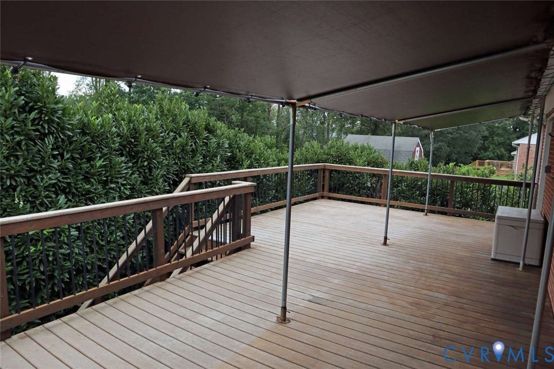 12853 Holly Lane, Manakin Sabot, VA 23103 Expansive wooden deck with a protective overhead canopy and a wooden railing with black balusters