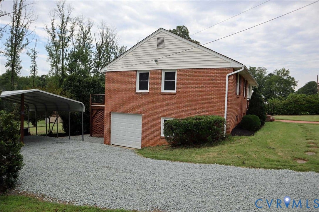 12853 Holly Lane, Manakin Sabot, VA 23103 Brick exterior with white siding accents and a single-car garage