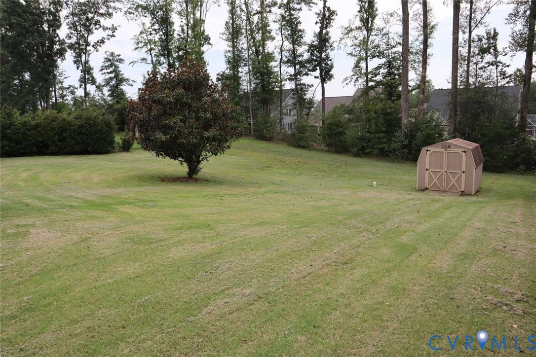 12853 Holly Lane, Manakin Sabot, VA 23103 Expansive lawn with a mature tree and a storage shed