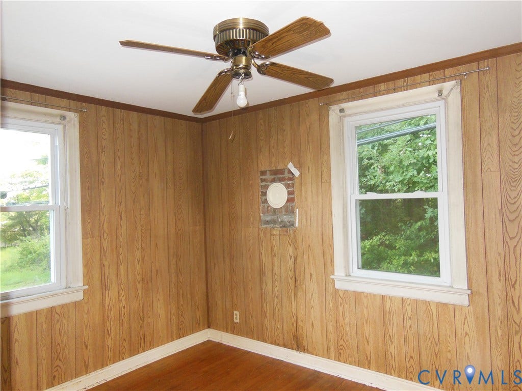 5307 Media Road, Richmond, VA 23225 Wood-finish wall paneling with coordinating trim, two single-hung windows, and a ceiling fan with light fixture