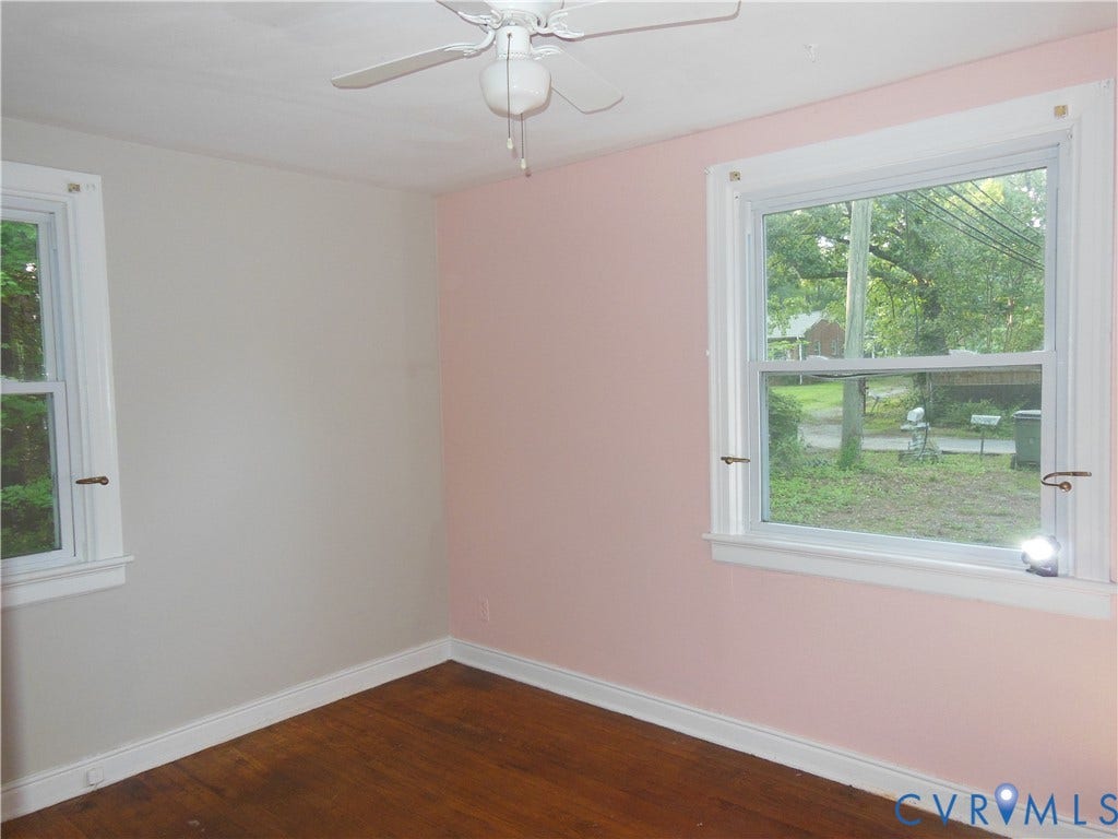 5307 Media Road, Richmond, VA 23225 Hardwood flooring, two double-hung windows with white trim, ceiling fan, crown molding, and baseboards