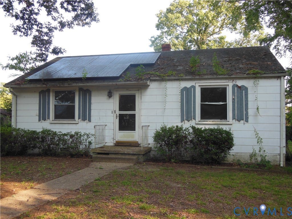 5307 Media Road, Richmond, VA 23225 White siding exterior with a pitched roof, solar panels, and a concrete front stoop