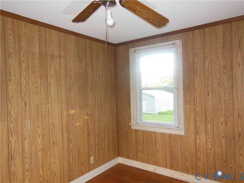 5307 Media Road, Richmond, VA 23225 Wood-finish wall paneling, ceiling fan with wood-finish blades, and a single window