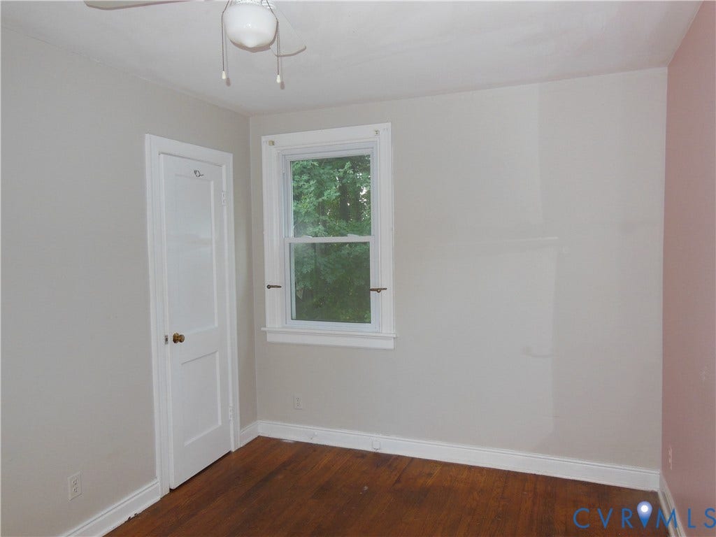 5307 Media Road, Richmond, VA 23225 Hardwood flooring, painted walls, white trim, white door, and a window