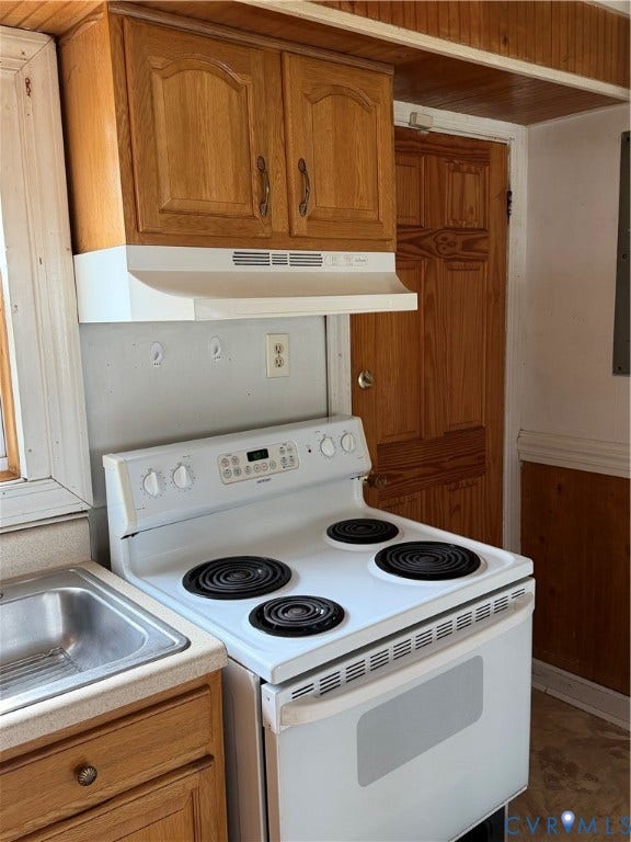 5101 Montpelier Street, Richmond, VA 23231 Wood-finish cabinetry with arched paneling, white electric range with four burners, and built-in stainless steel sink