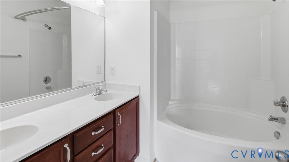 Dual vanity with a white countertop and wood-finish cabinetry
