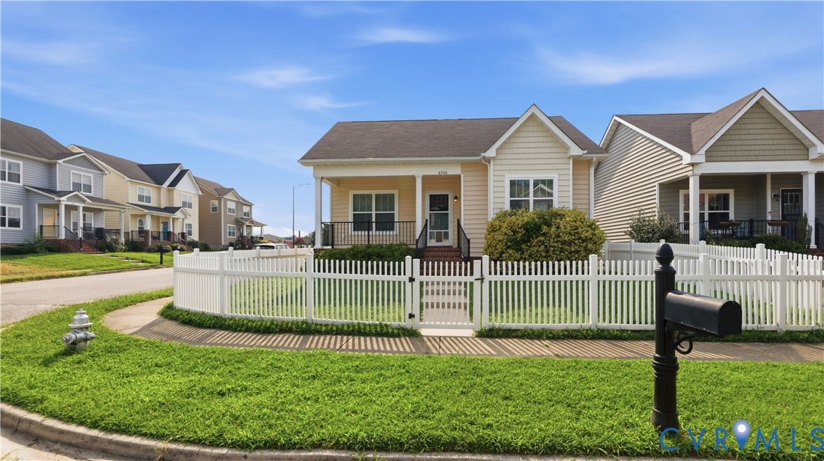 Single-story residence featuring light-colored siding and a covered front porch