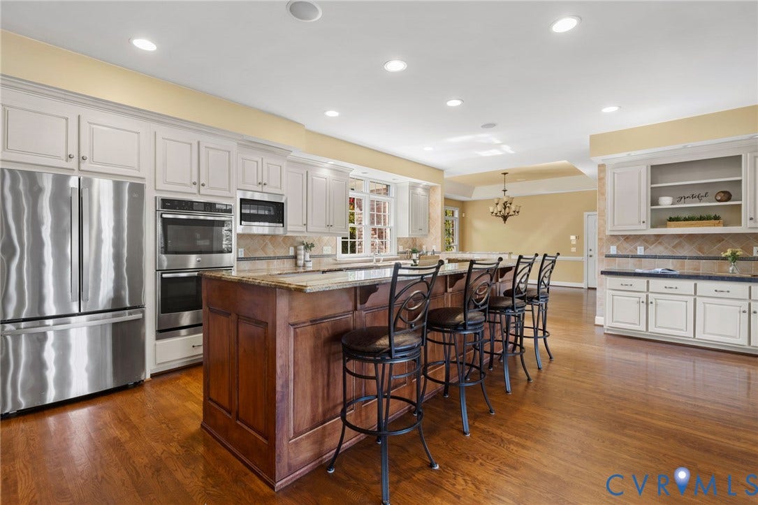 2365 Manakintown Ferry Road, Powhatan, VA 23113 Kitchen featuring a large central island, stainless steel appliances, recessed lighting, wood-finish flooring, and white cabinetry