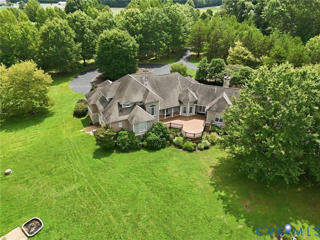 2365 Manakintown Ferry Road, Powhatan, VA 23113 Expansive property featuring a multi-level deck, mature trees, a paved driveway, and established landscaping